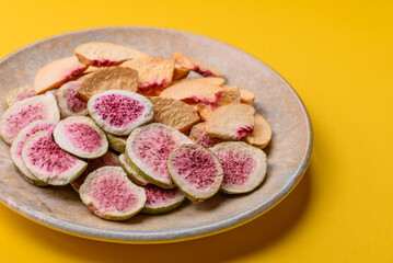 Dried sublimated fig and peach slices as an ingredient for desserts. Dried figs and peaches