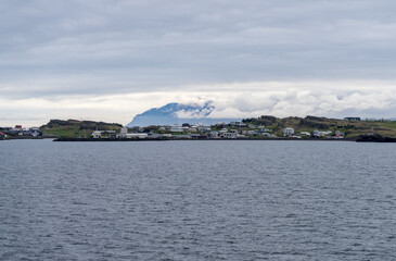 Panorama of the small town of Djupivogur in Eastern Iceland on a cold cloudy day seen from departing cruise ship
