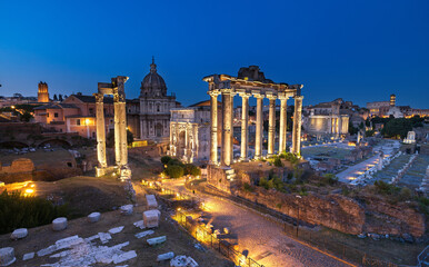 Naklejka premium Elevated view of the Imperial Forum in Rome at sunset, with ancient ruins bathed in warm golden light