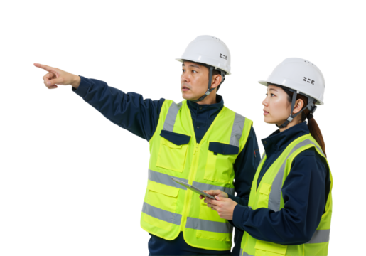 Two diligent construction professionals wearing safety gear collaborate on-site, demonstrating teamwork and precise project planning.