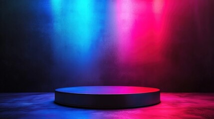A round stage illuminated with blue and pink lights in a dark room creating a vibrant and colorful scene