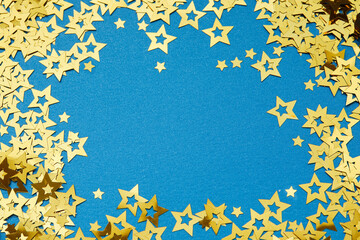 Golden stars glittering across vivid blue background, evoking festive mood for celebratory holiday designs and decorative compositions