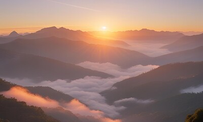 Obraz premium Sunrise Over Mountain Range with Misty Clouds