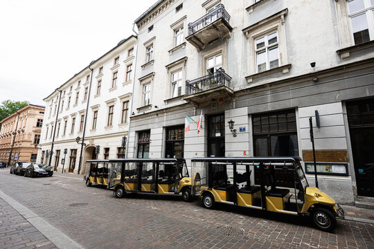 Tourist carts parked along historic street in Krakow, Poland with classic architecture