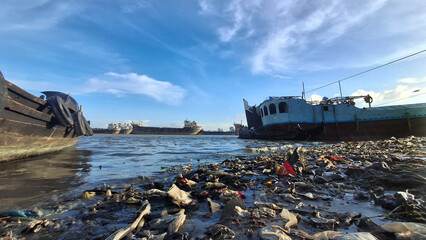 Day by day Karnaphuli river is getting filled with polythene and boards
