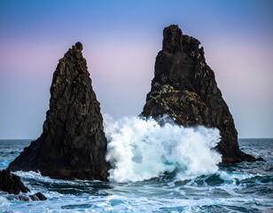 Dramatic ocean waves crashing against volcanic rocks