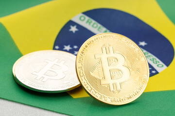 Bitcoin cryptocurrency coins on national flag of Brazil. Crypto law regulation concept