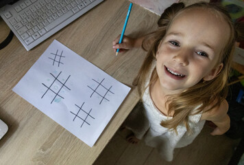 Girl playing educational tic-tac-toe game
