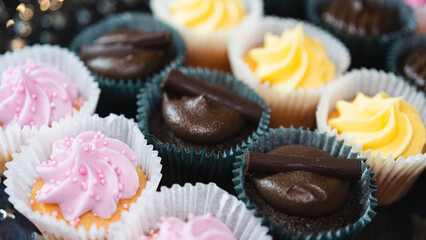 Beautiful chocolate and assorted cupcakes on an elegant plate, perfect for parties or family gatherings. Soft lighting and shallow depth of field.