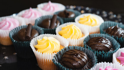 Beautiful chocolate and assorted cupcakes on an elegant plate, perfect for parties or family gatherings. Soft lighting and shallow depth of field.