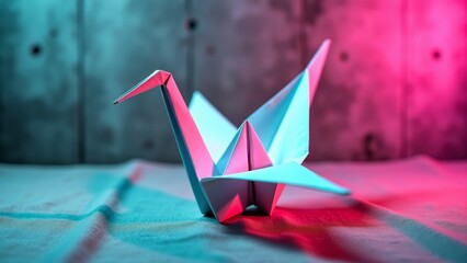 White origami crane against concrete wall