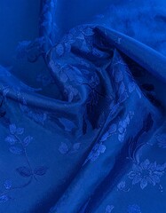 Deep blue fabric with floral embroidery