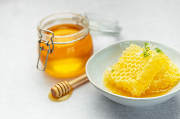 Honey, honeycomb and bee pollen creating delicious golden composition