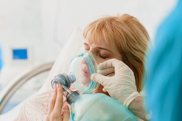Blonde Caucasian Woman in Labor with Oxygen Mask Assistance in Bright Hospital Environment