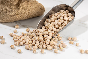 Chickpea on scoop on White marble Background. Cicer arietinum