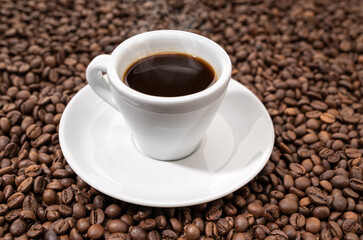 Espresso Coffee cup on roasted beans background