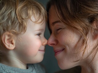 Affectionate mother touching noses with her young son