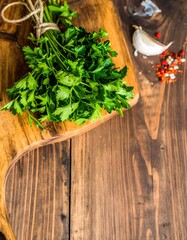 Fresh parsley bunch on wooden board