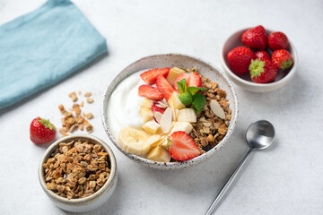 Healthy fitness diet meal: Greek Yogurt bowl with strawberry, banana and granola