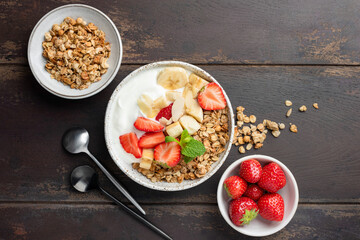 Healthy fitness diet meal: Greek Yogurt bowl with strawberry, banana and granola