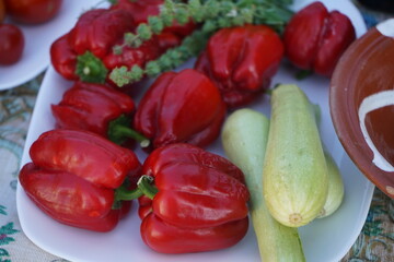 An enticing image of freshly harvested zucchini & ripe red peppers, ready to be prepared. Sourced from Crete, Greece, this photo is ideal for Mediterranean, organic food, and healthy lifestyle content
