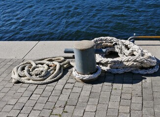 Seile und Tampen am Poller am Flussufer