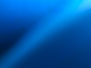 Abstract blue background with a diagonal light beam