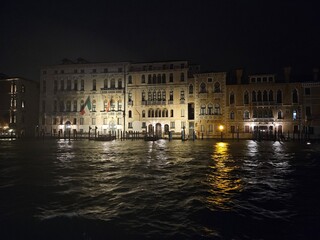 Fototapeta premium Illuminated historic Venetian palaces at night along the Grand Canal in Venice Italy