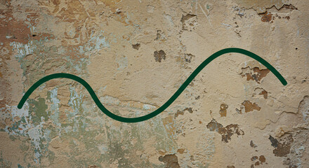 Fototapeta premium Green wavy line on a textured, weathered, and cracked plaster wall background