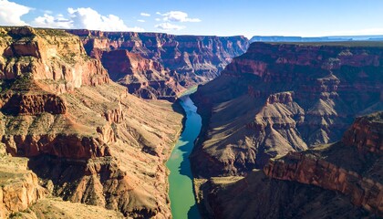 High-angle view of the Grand Canyon with a river winding through the deep chasm.