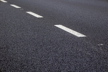 Close-up of asphalt road markings traffic rules and road safety regulations.