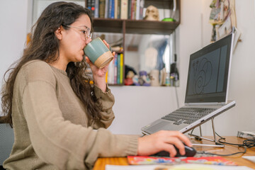 Graphic designer drinking coffee and working from home studio