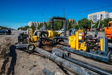 Cleaning sewer manholes by specialized pump machine on the street