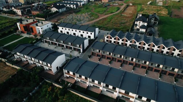 complex of modern townhouses  with more then 50 identical houses in a suburban area, drone footage