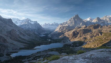 Obraz premium Panoramic vista of majestic snow-capped mountains and serene alpine lakes within a deep, rugged valley, showcasing untouched natural beauty under a vast, clear sky