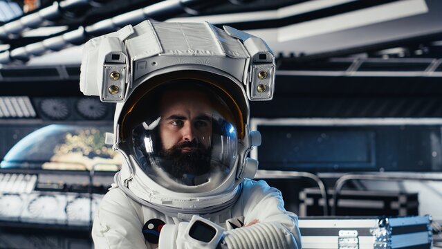 Portrait of astronaut wearing helmet before stepping out for scheduled operations outside space station. Man in cosmonaut suit in starship approaching distant planetary surface