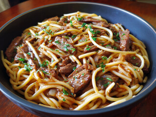 Bucatini pasta with delicious braised beef and parsley in a bowl