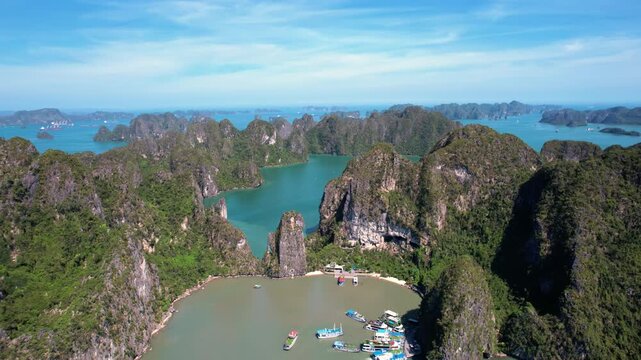 Ha Long Bay, Vietnam: Breathtaking aerial drone flight over Hạ Long Bay, panoramic view of iconic limestone karsts in emerald water - UNESCO landscape panorama of Southeast Asia from above

