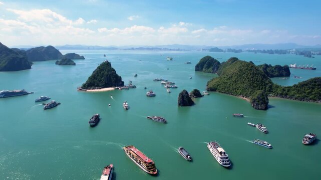 Ha Long Bay, Vietnam: Breathtaking aerial drone flight over Hạ Long Bay, panoramic view of iconic limestone karsts in emerald water - UNESCO landscape panorama of Southeast Asia from above
