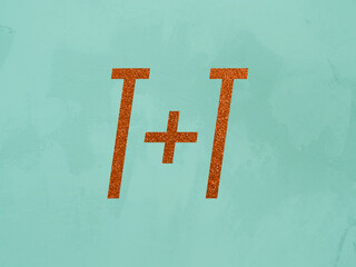 T+T, " T plus T", two letter T connected with plus sign in orange glitter font on light turquoise teal background symbolizing the initials of two people with first names beginning with the letter T