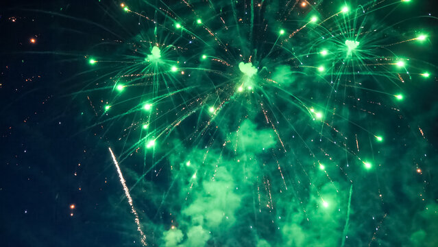 Green fireworks exploding in the night sky - Powered by Adobe