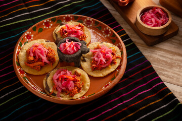 Panuchos, a typical dish from Yucatan, Mexico. A handmade, fried corn tortilla filled with beans,...