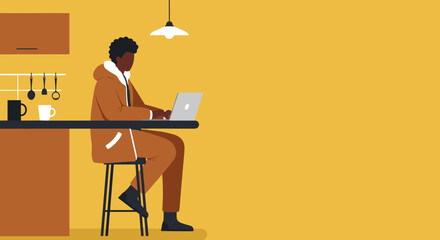 African American man working remotely on a laptop at his kitchen counter, depicting modern home office, online education, or digital nomad lifestyle.