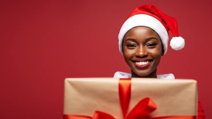 Woman dressed as Santa holds a wrapped Christmas gift with a red ribbon. - Powered by Adobe