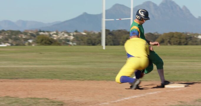 On pitch male first baseman catching throw to tag baserunner out at second, copy space