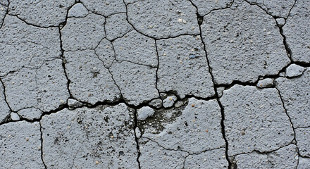 Obraz premium Cracked concrete texture background with detailed fissures, perfect for design and grunge themes