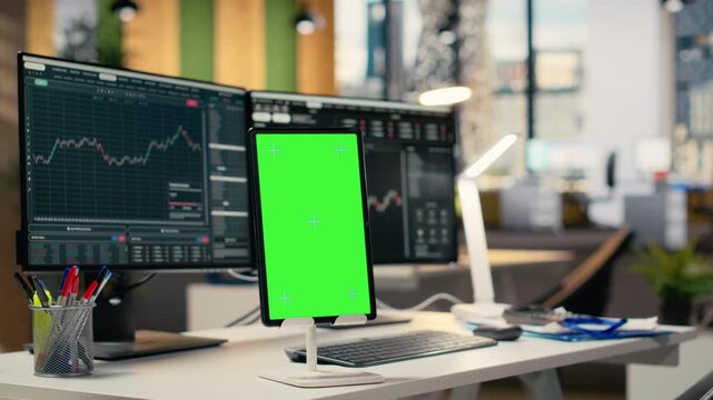 Close up of isolated screen tablet displaying stock market graphs in proprietary firm office. Mockup device on brokerage workspace desk used for stock exchange analysis and strategy planning