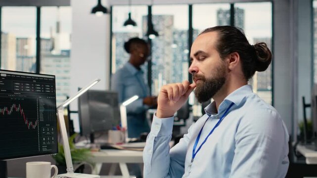 Trader in office closing eyes to do daydreaming, visualizing financial independence and future success. Cheerful prop firm employee at desk lost in thought, picturing prosperous trade, camera B