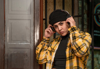 woman listening to music with headphones plaid shirt