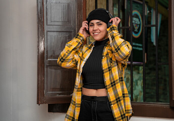 Woman with headphones posing looking at the camera